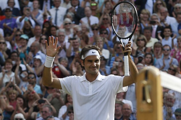 Roger Federer of Switzerland celebrates defeating Milos Raonic of Canada during their men’s singles semifinal match at the All England Lawn Tennis Championships in Wimbledon, London, Friday, July 4, 2014. (AP Photo/Pavel Golovkin)