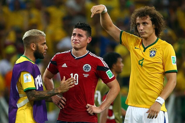 FORTALEZA, BRAZIL - JULY 04:  Dani Alves (L) and David Luiz of Brazil console James Rodriguez of Colombia after Brazil's 2-1 win during the 2014 FIFA World Cup Brazil Quarter Final match between Brazil and Colombia at Castelao on July 4, 2014 in Fortaleza, Brazil.  (Photo by Robert Cianflone/Getty Images)
