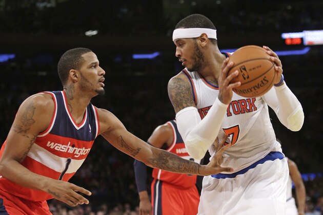 Washington Wizards' Trevor Ariza (1) defends New York Knicks' Carmelo Anthony (7) during the first half of an NBA basketball game Friday, April 4, 2014, in New York. (AP Photo/Frank Franklin II)