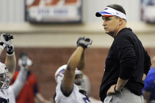 Buffalo Bills head coach Doug Marrone looks over his rookie players as they warm-up before taking part in drills during an NFL football rookie camp at the team's facility, Sunday, May 18, 2014, in Orchard Park, N.Y. (AP Photo/Gary Wiepert)