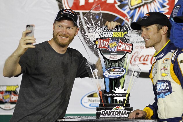 Dale Earnhardt Jr., left, takes a  photo with NASCAR Nationwide series auto race winner Kasey Kahne at Daytona International Speedway in Daytona Beach, Fla., Friday, July 4, 2014. (AP Photo/Terry Renna)
