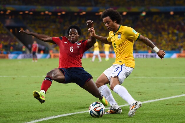FORTALEZA, BRAZIL - JULY 04:  Carlos Sanchez of Colombia challenges Marcelo of Brazil during the 2014 FIFA World Cup Brazil Quarter Final match between Brazil and Colombia at Castelao on July 4, 2014 in Fortaleza, Brazil.  (Photo by Laurence Griffiths/Getty Images)