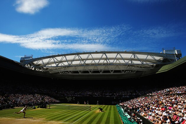 LONDON, ENGLAND - JULY 03:  General view of centre court as Eugenie Bouchard of Canada returns during her Ladies' Singles semi-final match against Simona Halep of Romania on day ten of the Wimbledon Lawn Tennis Championships at the All England Lawn Tennis and Croquet Club  on July 3, 2014 in London, England.  (Photo by Al Bello/Getty Images)