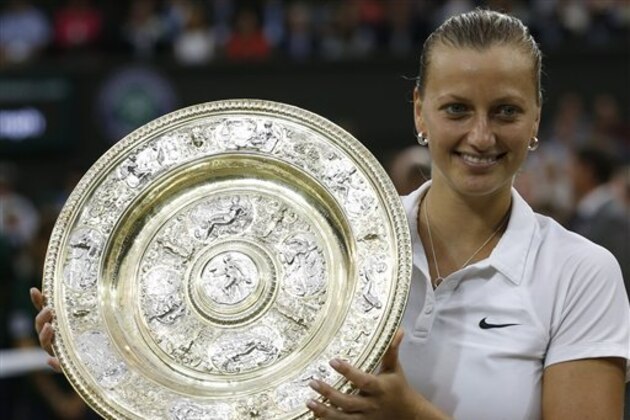 Petra Kvitova of Czech Republic holds the  trophy after winning the women's singles final against Eugenie Bouchard of Canada at the All England Lawn Tennis Championships in Wimbledon, London, Saturday, July 5, 2014. (AP Photo/Sang Tan)