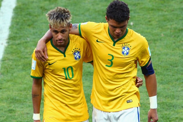 BELO HORIZONTE, BRAZIL - JUNE 28:  Neymar and Thiago Silva of Brazil walk off the pitch after defeating Chile in the penalty shootout in the 2014 FIFA World Cup Brazil round of 16 match between Brazil and Chile at Estadio Mineirao on June 28, 2014 in Belo Horizonte, Brazil.  (Photo by Ian Walton/Getty Images)