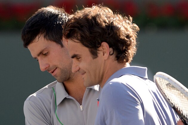 Mar 16, 2014; Indian Wells, CA, USA; Novak Djokovic (SRB) with Roger Federer (SUI) after he won the final of the BNP Paribas Open at the Indian Wells Tennis Garden. Djokovic won 6-3, 3-6, 7-6. Mandatory Credit: Jayne Kamin-Oncea-USA TODAY Sports