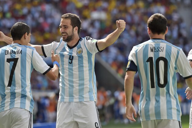 Argentina's Gonzalo Higuain, right, celebrates with Angel di Maria and Lionel Messi after he scored the opening goal during the World Cup quarterfinal soccer match between Argentina and Belgium at the Estadio Nacional in Brasilia, Brazil, Saturday, July 5, 2014. (AP Photo/Martin Meissner)