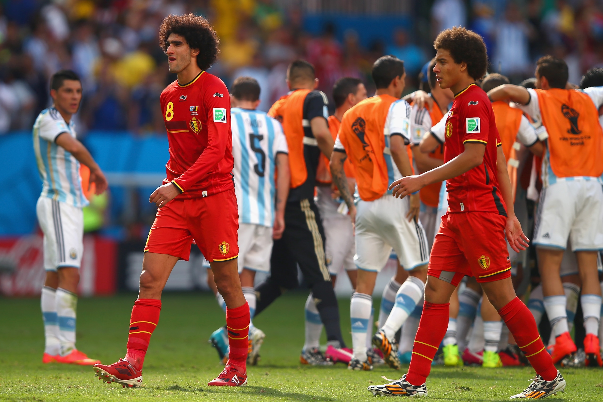 BRASILIA, BRAZIL - JULY 05: Marouane Fellaini (L) and Axel Witsel of Belgium look on as Argentina celebrate their 1-0 win during the 2014 FIFA World Cup Brazil Quarter Final match between Argentina and Belgium at Estadio Nacional on July 5, 2014 in Brasilia, Brazil.  (Photo by Clive Rose/Getty Images)