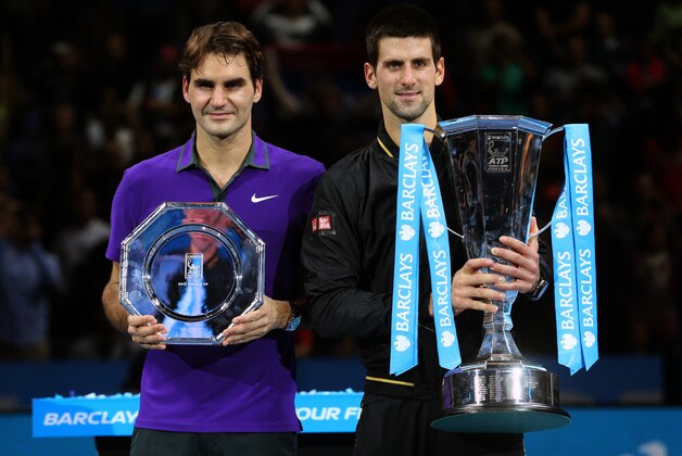 LONDON, ENGLAND - NOVEMBER 12:  Novak Djokovic of Serbia poses with Roger Federer of Switzerland as he holds the trophy following their men's singles final match against Roger Federer of Switzerland during day eight of the ATP World Tour Finals at O2 Arena on November 12, 2012 in London, England.  (Photo by Julian Finney/Getty Images)