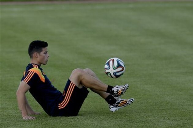 Colombia's James Rodriguez plays with a ball during a training session the day before the World Cup quarterfinals soccer match between Colombia and Brazil, in Fortaleza, Brazil, Thursday, July 3, 2014. (AP Photo/Natacha Pisarenko)