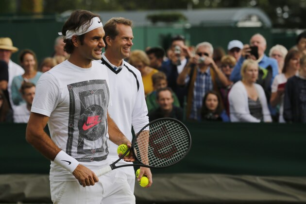 Roger Federer of Switzerland attends a practice session with his coach Stefan Edberg, right, at the All England Lawn Tennis Championships at Wimbledon, London, Saturday July 5, 2014. Federer will play in the men's singles final against Novak Djokovic of Serbia on Sunday. (AP Photo/Ben Curtis)