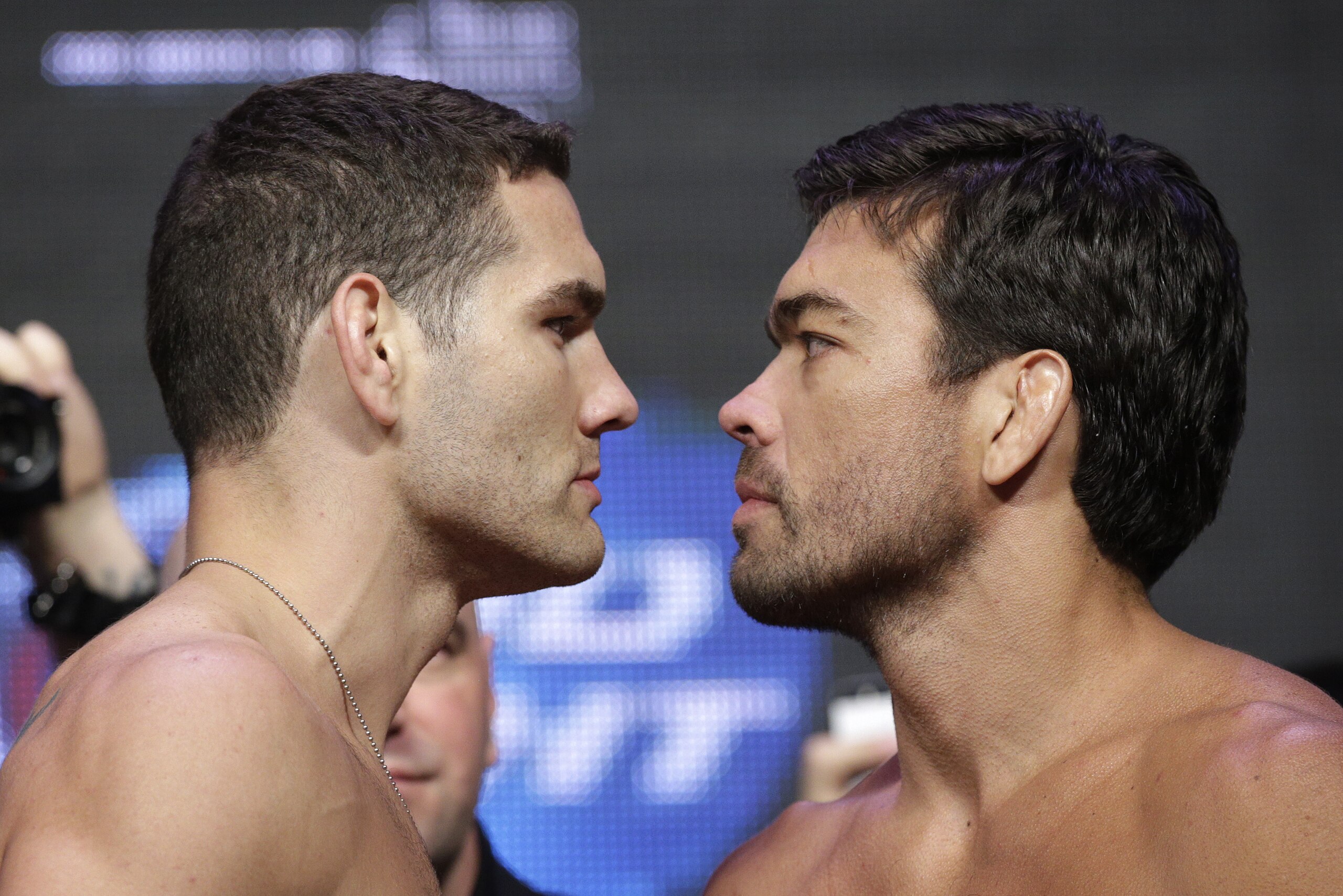 Chris Weidman, left, and Lyoto Machida pose for photographers during a weigh-in for the UFC 175 mixed martial arts event at the Mandalay Bay, Friday, July 4, 2014, in Las Vegas. The two are scheduled to fight in a middleweight title bout on Saturday in Las Vegas. (AP Photo/John Locher)