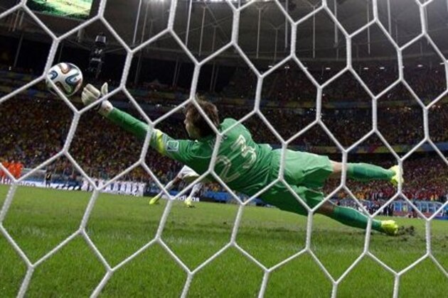 Netherlands' goalkeeper Tim Krul makes a save on a shot by Costa Rica's Michael Umana during a penalty shootout in extra time during the World Cup quarterfinal soccer match at the Arena Fonte Nova in Salvador, Brazil, Saturday, July 5, 2014. The Netherlands defeated Costa Rica 4-3 in penalties after a 0-0 tie. (AP Photo/Wong Maye-E)