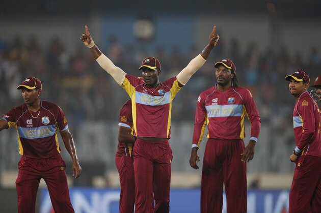 West Indies' captain Darren Sammy, center, celebrates with teammates the dismissal of Sri Lanka's Mahela Jayawardena during their ICC Twenty20 Cricket World Cup semi-final match in Dhaka, Bangladesh, Thursday, April 3, 2014. (AP Photo/Aijaz Rahi)