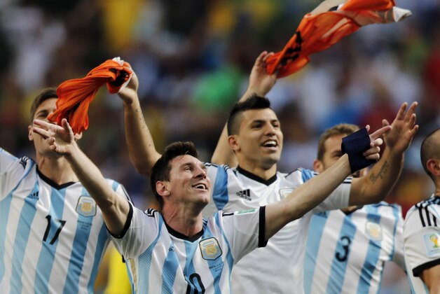 Argentina's Lionel Messi and teammates celebrate at the end of the World Cup quarterfinal soccer match between Argentina and Belgium at the Estadio Nacional in Brasilia, Brazil, Saturday, July 5, 2014. Argentina won 1-0. (AP Photo/Thanassis Stavrakis)