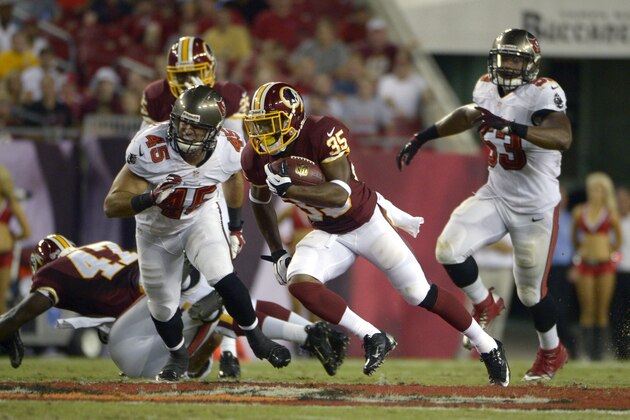 Washington Redskins running back Chris Thompson (35) returns a punt in front of Tampa Bay Buccaneers linebacker Dom DeCicco (45) and linebacker Najee Goode (53) during the first half of a preseason NFL football game in Tampa, Fla., Thursday, Aug. 29, 2013.(AP Photo/Phelan M. Ebenhack)