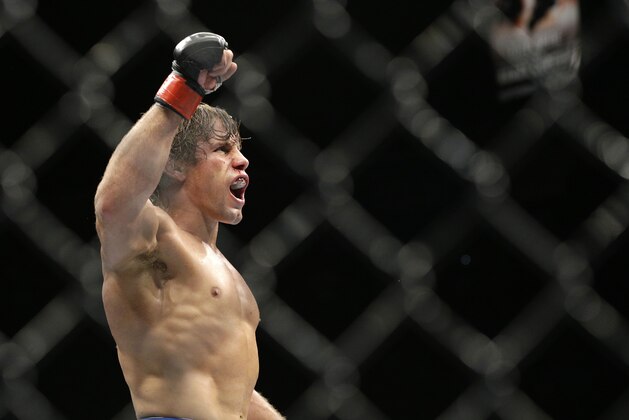 Urijah Faber celebrates after defeating Alex Caceres in their bantamweight mixed martial arts bout at UFC 175 on Saturday, July 5, 2014, in Las Vegas. (AP Photo/John Locher)