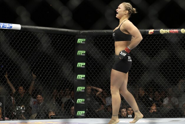 Ronda Rousey celebrates after defeating Alexis Davis in their women's mixed martial arts bantamweight title bout at UFC 175 Saturday, July 5, 2014, in Las Vegas. (AP Photo/John Locher) Ronda Rousey celebrates after defeating Alexis Davis in their women's mixed martial arts bantamweight title bout at UFC 175 Saturday, July 5, 2014, in Las Vegas. (AP Photo/John Locher)