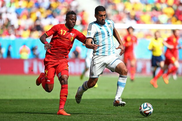 BRASILIA, BRAZIL - JULY 05: Divock Origi of Belgium challenges Ezequiel Garay of Argentina during the 2014 FIFA World Cup Brazil Quarter Final match between Argentina and Belgium at Estadio Nacional on July 5, 2014 in Brasilia, Brazil.  (Photo by Julian Finney/Getty Images)