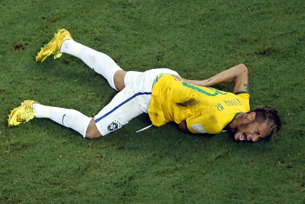 Brazil's Neymar grimaces in pain during the World Cup quarterfinal soccer match between Brazil and Colombia at the Arena Castelao in Fortaleza, Brazil, Friday, July 4, 2014. Brazil's team doctor says Neymar will miss the rest of the World Cup after breaking a vertebrae during the team's quarterfinal win over Colombia. (AP Photo/Fabrizio Bensch, Pool)