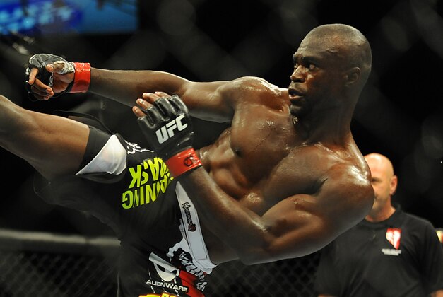 Jul 5, 2014; Las Vegas, NV, USA; Uriah Hall (red gloves) lands a kick to Thiago Santos (blue gloves) during a middleweight fight  at Mandalay Bay Events Center. Mandatory Credit: Stephen R. Sylvanie-USA TODAY Sports