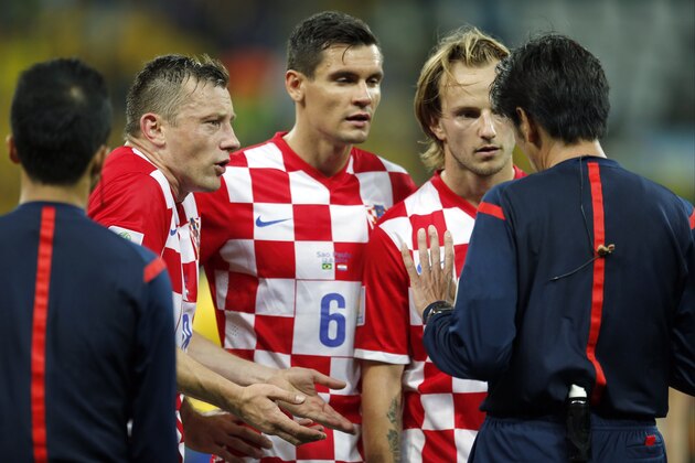 Croatia's Ivan Rakitic, second from right, Dejan Lovren (6) and Ivica Olic complain to referee Yuichi Nishimura, right, from Japan, after Nishimura issued a penalty against Croatia during the group A World Cup soccer match between Brazil and Croatia in the opening game of the tournament at Itaquerao Stadium in Sao Paulo, Brazil, Thursday, June 12, 2014. Brazil was given a penalty kick following the call resulting in a goal by Neymar. (AP Photo/Frank Augstein) Croatia's Ivan Rakitic, second from right, Dejan Lovren (6) and Ivica Olic complain to referee Yuichi Nishimura, right, from Japan, after Nishimura issued a penalty against Croatia during the group A World Cup soccer match between Brazil and Croatia in the opening game of the tournament at Itaquerao Stadium in Sao Paulo, Brazil, Thursday, June 12, 2014. Brazil was given a penalty kick following the call resulting in a goal by Neymar. (AP Photo/Frank Augstein)