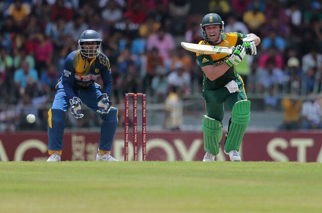 South African one day international team captain AB de Villiers plays a shot as Sri Lankan wicket keeper Kumar Sangakkara watches during the first one-day international cricket match between Sri Lanka and South Africa in Colombo, Sri Lanka, Sunday, July 6, 2014. (AP Photo/Eranga Jayawardena)