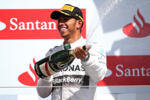NORTHAMPTON, ENGLAND - JULY 06:  Lewis Hamilton of Great Britain and Mercedes GP celebrates on the podium after winning the British Formula One Grand Prix at Silverstone Circuit on July 6, 2014 in Northampton, United Kingdom.  (Photo by Mark Thompson/Getty Images)