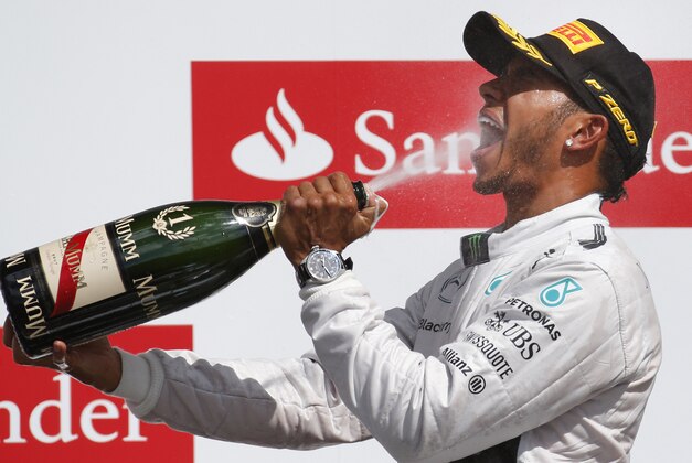 Britain's Lewis Hamilton of Mercedes drinks champagne as he celebrates after winning the British Formula One Grand Prix at Silverstone circuit, Silverstone, England, Sunday, July 6, 2014. Finland's Valtteri Bottas of Williams finished second, and Australia's Daniel Ricciardo of Red Bull finished third. (AP Photo/Lefteris Pitarakis) Britain's Lewis Hamilton of Mercedes drinks champagne as he celebrates after winning the British Formula One Grand Prix at Silverstone circuit, Silverstone, England, Sunday, July 6, 2014. Finland's Valtteri Bottas of Williams finished second, and Australia's Daniel Ricciardo of Red Bull finished third. (AP Photo/Lefteris Pitarakis)