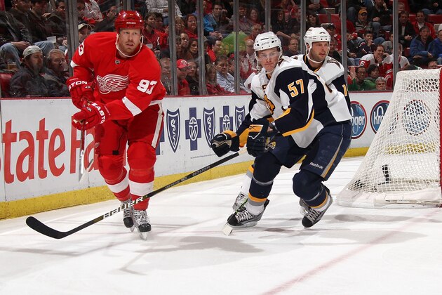 DETROIT - MARCH 13: Johan Franzen #93 of the Detroit Red Wings passes the puck past Tyler Myers #57 of the Buffalo Sabres during an NHL game at Joe Louis Arena on March 13, 2010 in Detroit, Michigan.  Detroit defeated Buffalo 3-2 in OT.  (Photo by Dave Reginek/NHLI via Getty Images)