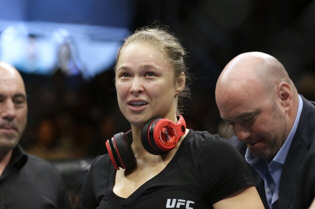 Ronda Rousey looks up after defeating Alexis Davis in their women's mixed martial arts bantamweight title bout at UFC 175 on Saturday, July 5, 2014, in Las Vegas. (AP Photo/John Locher)