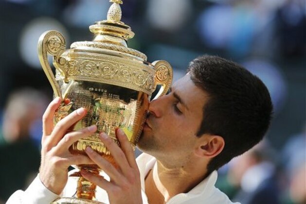 Novak Djokovic of Serbia kisses the trophy after defeating Roger Federer of Switzerland in the men's singles final at the All England Lawn Tennis Championships in Wimbledon, London, Sunday July 6, 2014. (AP Photo/Ben Curtis) Novak Djokovic of Serbia kisses the trophy after defeating Roger Federer of Switzerland in the men's singles final at the All England Lawn Tennis Championships in Wimbledon, London, Sunday July 6, 2014. (AP Photo/Ben Curtis)