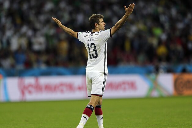 Germany's Thomas Mueller raises his arms after Germany defeated Algeria 2-1 in extra time during the World Cup round of 16 soccer match between Germany and Algeria at the Estadio Beira-Rio in Porto Alegre, Brazil, Monday, June 30, 2014. (AP Photo/Kirsty Wigglesworth)