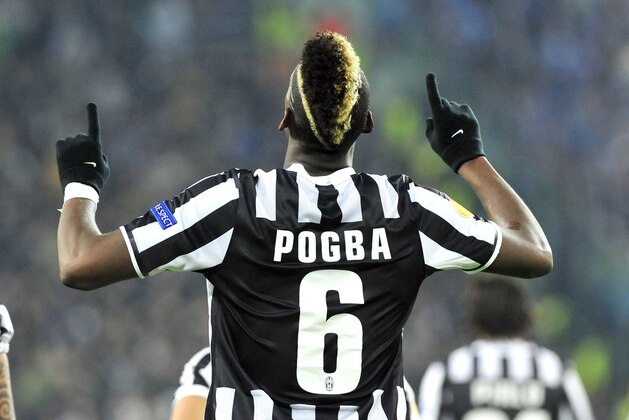 Juventus midfielder Paul Pogba, of France, celebrates after scoring during the Europa League, round of 16th, soccer match between Juventus and Trabzonspor at the Juventus stadium, in Turin, Italy, Thursday, Feb. 20, 2014. (AP Photo/Massimo Pinca)