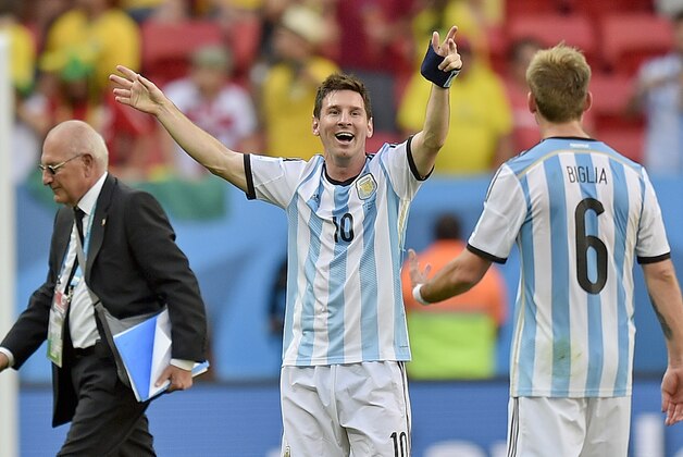 Argentina's Lionel Messi greets Lucas Biglia after the World Cup quarterfinal soccer match between Argentina and Belgium at the Estadio Nacional in Brasilia, Brazil, Saturday, July 5, 2014. Argentina won the match 1-0. (AP Photo/Martin Meissner)