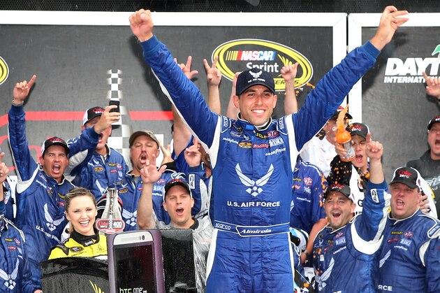 DAYTONA BEACH, FL - JULY 06:  Aric Almirola, driver of the #43 United States Air Force Ford, celebrates in Victory Lane after winning the NASCAR Sprint Cup Series Coke Zero 400 after the race was called for weather at Daytona International Speedway on July 6, 2014 in Daytona Beach, Florida.  (Photo by Chris Graythen/Getty Images)
