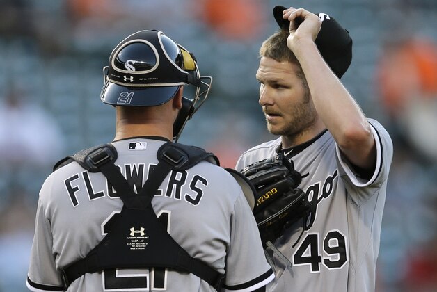 Chicago White Sox starting pitcher Chris Sale, right, speaks with catcher Tyler Flowers on the mount after Baltimore Orioles' Delmon Young singled in the first inning of a baseball game, Monday, June 23, 2014, in Baltimore. Baltimore scored two runs in the first. (AP Photo/Patrick Semansky)