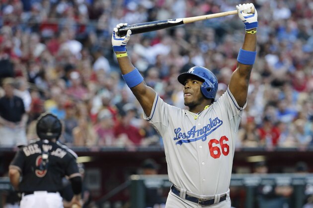 Los Angeles Dodgers' Yasiel Puig reacts after striking out to end the top of the fifth inning of a baseball game as Arizona Diamondbacks catcher Tuffy Gosewisch heads to the dugout on Saturday, May 17, 2014, in Phoenix. (AP Photo/Matt York)