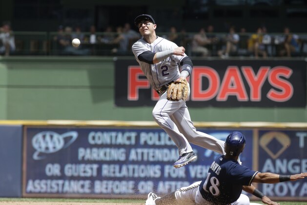 Milwaukee Brewers' Khris Davis is out at second as Colorado Rockies' Troy Tulowitzki turns a double play on a ball hit by Mark Reynolds during the second inning of a baseball game Sunday, June 29, 2014, in Milwaukee. (AP Photo/Morry Gash)