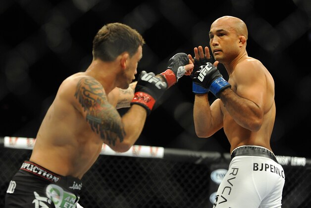 Jul 6, 2014; Las Vegas, NV, USA; BJ Penn (blue gloves) blocks a punch by Frankie Edgar (red gloves) during a featherweight fight at Mandalay Bay Events Center. Mandatory Credit: Stephen R. Sylvanie-USA TODAY Sports Jul 6, 2014; Las Vegas, NV, USA; BJ Penn (blue gloves) blocks a punch by Frankie Edgar (red gloves) during a featherweight fight at Mandalay Bay Events Center. Mandatory Credit: Stephen R. Sylvanie-USA TODAY Sports
