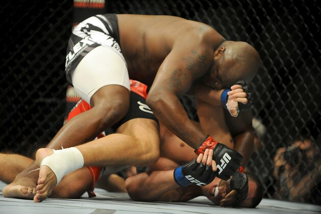 Jul 6, 2014; Las Vegas, NV, USA; Derrick Lewis (red gloves) takes down Guto Inocente (blue gloves) during a heavyweight fight at Mandalay Bay Events Center. Mandatory Credit: Stephen R. Sylvanie-USA TODAY Sports