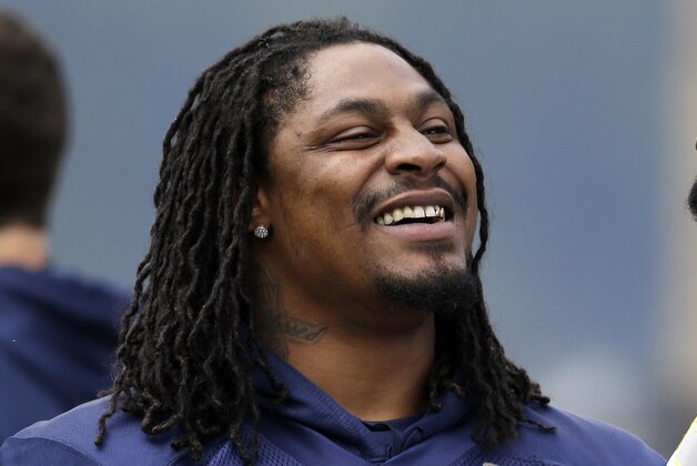Seattle Seahawks' Marshawn Lynch stands on the field at an NFL football minicamp practice Wednesday, June 18, 2014, in Renton, Wash. (AP Photo/Elaine Thompson)