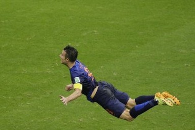 In this Friday, June 13, 2014 photo, Netherlands' Robin van Persie heads the ball to score during the group B World Cup soccer match between Spain and the Netherlands at the Arena Ponte Nova in Salvador, Brazil. The Dutchman's header that looped over a stranded Iker Casillas in the Spain goal was not only very special but historic. By taking his tally to 45 goals for his country, the Manchester United forward also became the first Dutch player to score in three consecutive World Cups. (AP Photo/Christophe Ena)
