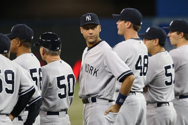 TORONTO, CANADA - APRIL 4: Derek Jeter #2 of the New York Yankees stands during lineup introductions before the start of MLB game action against the Toronto Blue Jays on April 4, 2014 at Rogers Centre in Toronto, Ontario, Canada. (Photo by Tom Szczerbowski/Getty Images)