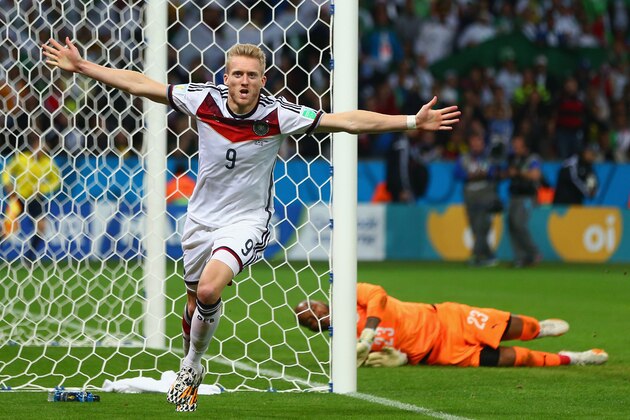 PORTO ALEGRE, BRAZIL - JUNE 30:  Andre Schuerrle of Germany celebrates scoring his team's first goal in extra-time past goalkeeper Rais M'Bolhi of Algeria during the 2014 FIFA World Cup Brazil Round of 16 match between Germany and Algeria at Estadio Beira-Rio on June 30, 2014 in Porto Alegre, Brazil.  (Photo by Jamie Squire/Getty Images)