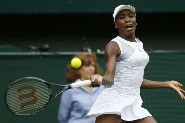 Venus Williams of U.S. returns to Petra Kvitova of the Czech Republic during their women's singles match at the All England Lawn Tennis Championships in Wimbledon, London, Friday, June 27, 2014. (AP Photo/Sang Tan)