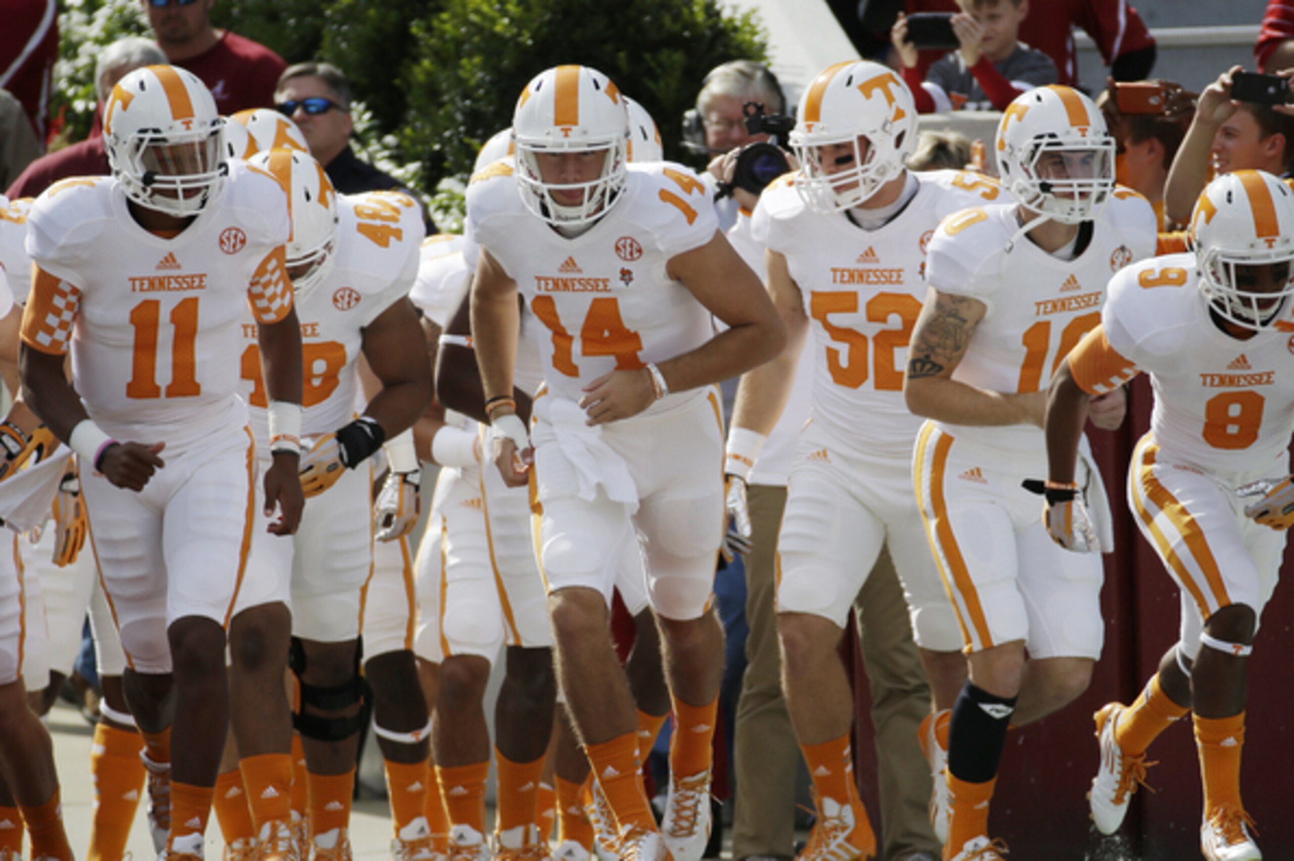 Tennessee quarterback Justin Worley (14) leads the Volunteers onto the field prior to an NCAA college football game against Alabama in Tuscaloosa, Ala., Saturday, Oct. 26, 2013. (AP Photo/Dave Martin)
