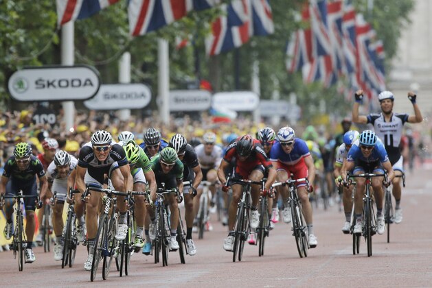 A teammate, rear right, celebrates as Germany's sprinter Marcel Kittel, front left, crosses the finish line to win the third stage of the Tour de France cycling race over 155 kilometers (96.3 miles) with start in Cambridge and finish in London, England, Monday, July 7, 2014. (AP Photo/Christophe Ena)