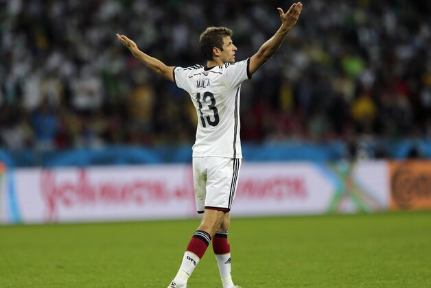 Germany's Thomas Mueller raises his arms after Germany defeated Algeria 2-1 in extra time during the World Cup round of 16 soccer match between Germany and Algeria at the Estadio Beira-Rio in Porto Alegre, Brazil, Monday, June 30, 2014. (AP Photo/Kirsty Wigglesworth)