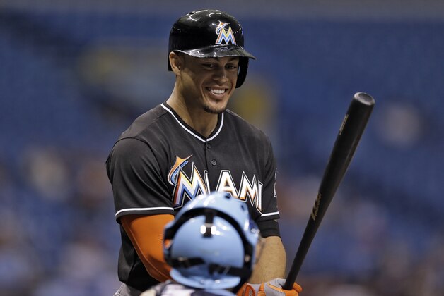 Miami Marlins' Giancarlo Stanton smiles as he talk to Tampa Bay Rays catcher Jose Molina prior to batting during the first inning of an interleague baseball game Wednesday, June 4, 2014, in St. Petersburg, Fla. (AP Photo/Chris O'Meara)